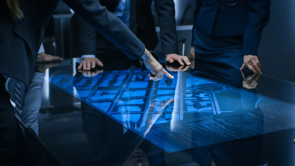 Team of Government Intelligence Agents Standing Around Digital Touch Screen Table and Satellite Tracking Suspect
